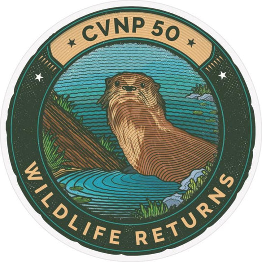 A circular sticker with "CVNP 50" at the top and "WILDLIFE RETURNS" at the bottom features an otter in a lake scene.