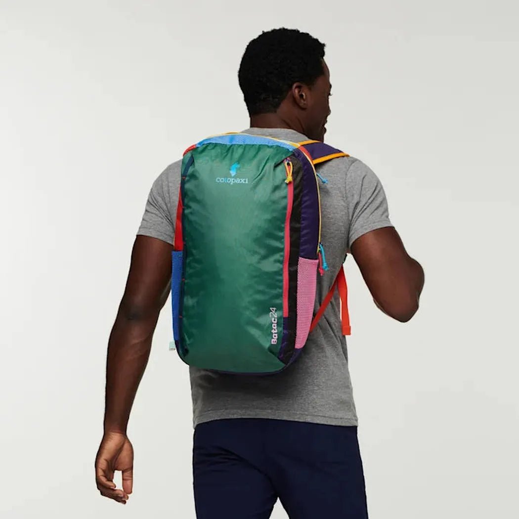 Back view of the Cotopaxi Batac 24L Pack in Del Dia II on a model against a plain white background.