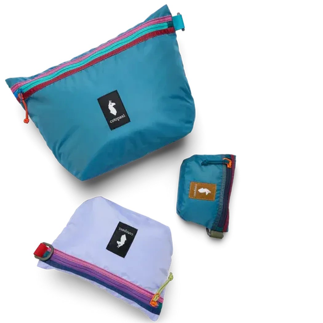 Three Del Dia Cotopaxi Cubo Pouch Organizers in different sizes and colors displayed on a white background.