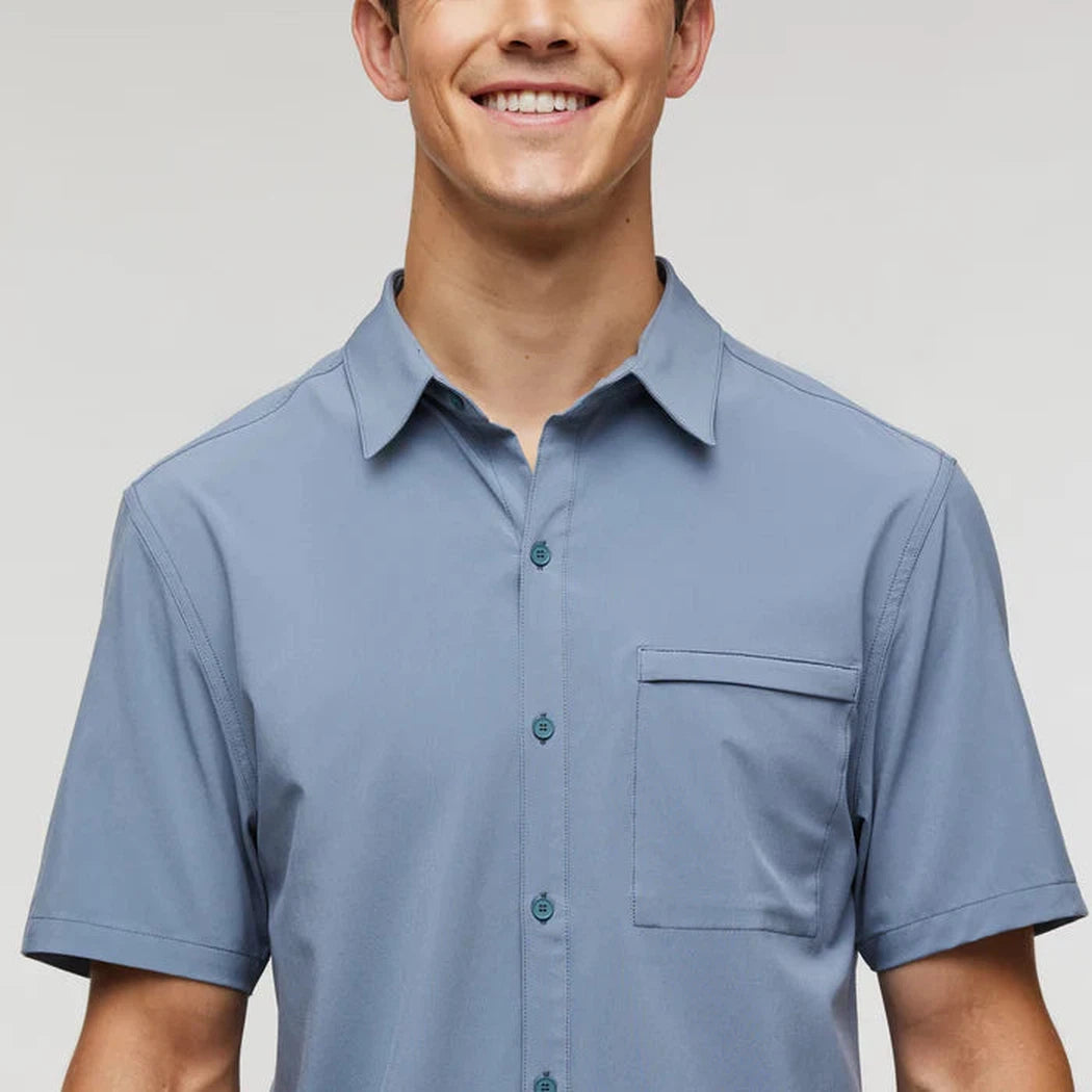 A front view of the Cotopaxi Men's Cambio Button Up in Tempest showing the chest pocket and short sleeves against a light background.