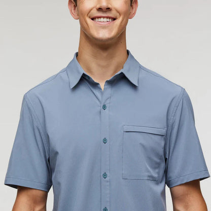 A front view of the Cotopaxi Men's Cambio Button Up in Tempest showing the chest pocket and short sleeves against a light background.