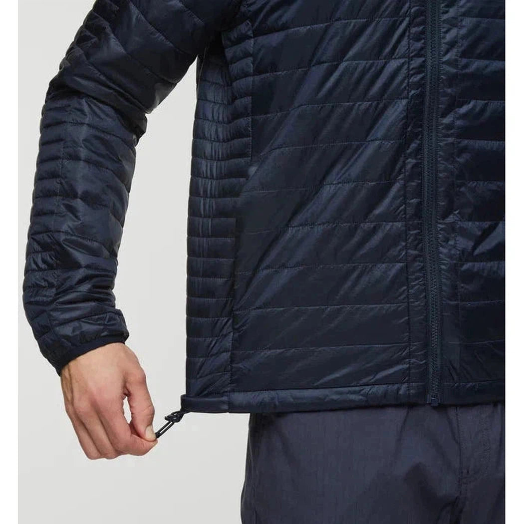 Side view of the Cotopaxi Men's Capa Insulated Hooded jacket in Carbon showing the adjustable hem cord against a plain background.