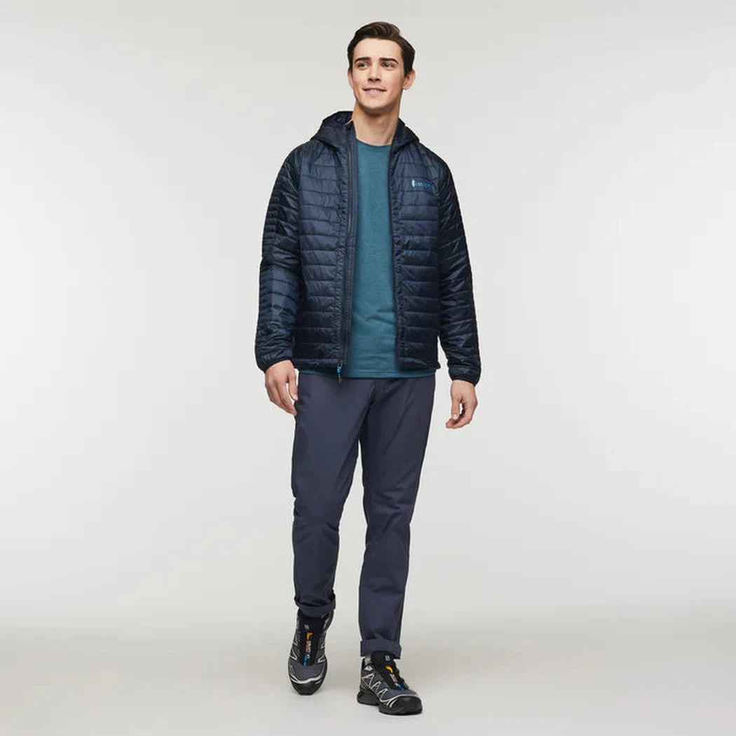 A front view of the Cotopaxi Men's Capa Insulated Hooded jacket in Carbon on a model against a plain white background.