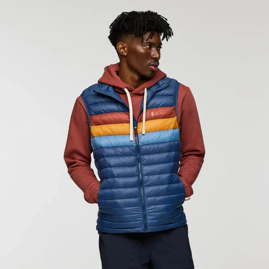 A front view of the Cotopaxi Men's Fuego Down Vest in DeepSeaStripes with a model wearing it against a plain background.