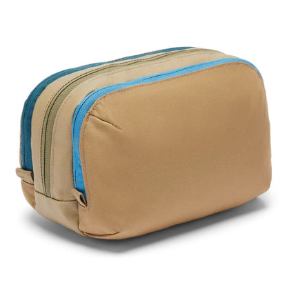 Side view of the Cotopaxi Nido Accessory Bag in Desert showing the blue zipper against a white background.