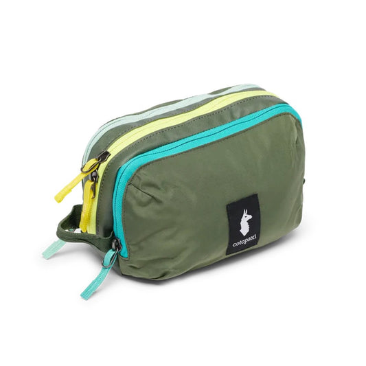 A front view of the Cotopaxi Nido Accessory Bag in Desert color with teal zippers and a white rabbit logo on a black patch, against a white background.