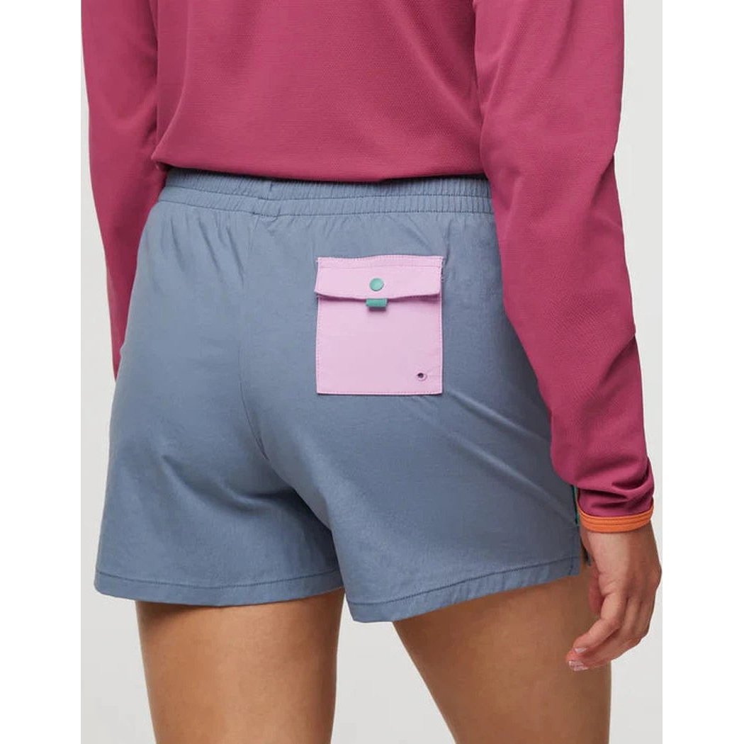 Back view of the Cotopaxi Women's Brinco Short in Tempest showing the back pocket and model wearing it.