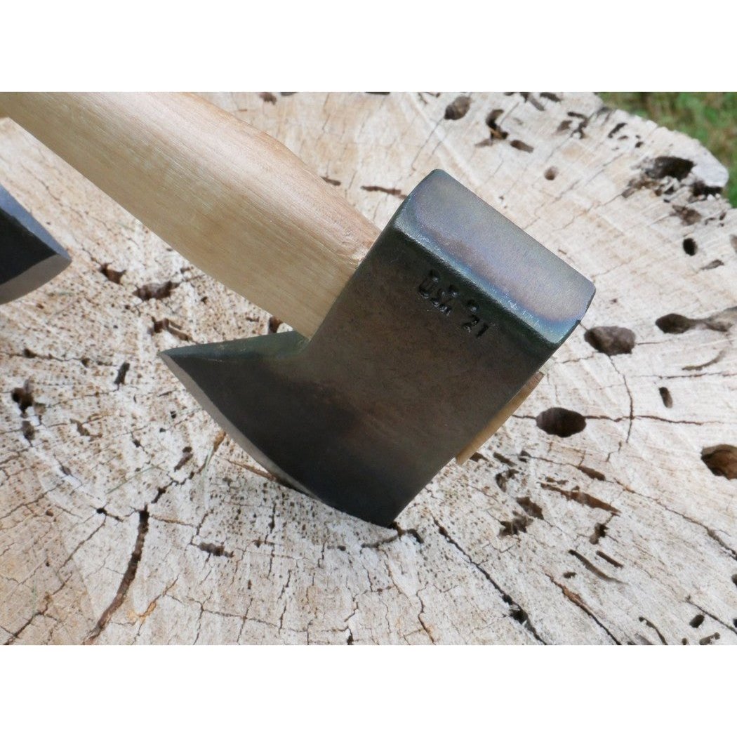 A close-up of the Council Tool Co. Hudson Bay Camp Axe 2lbs with 18" handle resting on a tree stump.