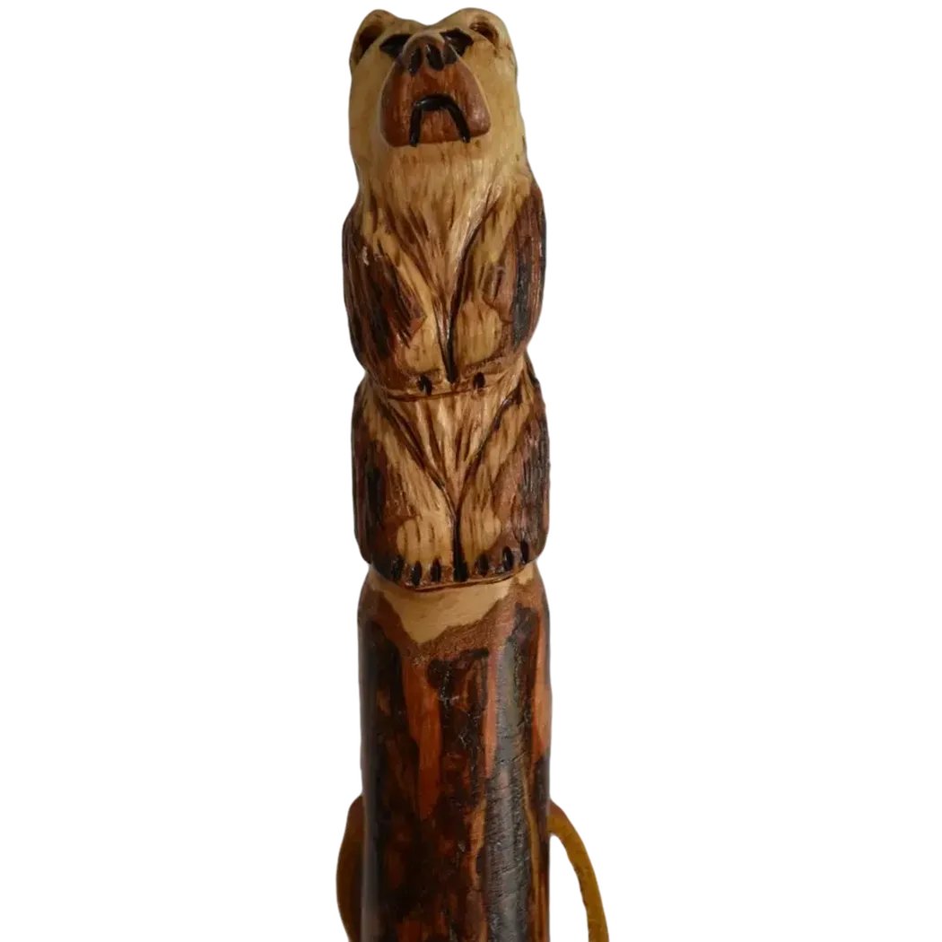 A close-up of the Creation Carvings Walking Stick with Bear Carving, showing the detailed bear carving and natural wood texture against a white background.