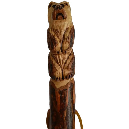 A close-up of the Creation Carvings Walking Stick with Bear Carving, showing the detailed bear carving and natural wood texture against a white background.