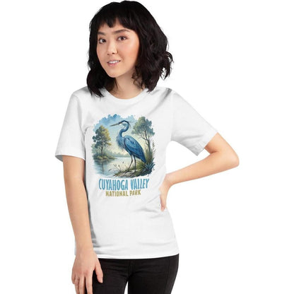 A woman wearing a white Cuyahoga Valley Clothing Company CVNP Blue Heron T - Shirt poses with one hand on her hip against a white background.
