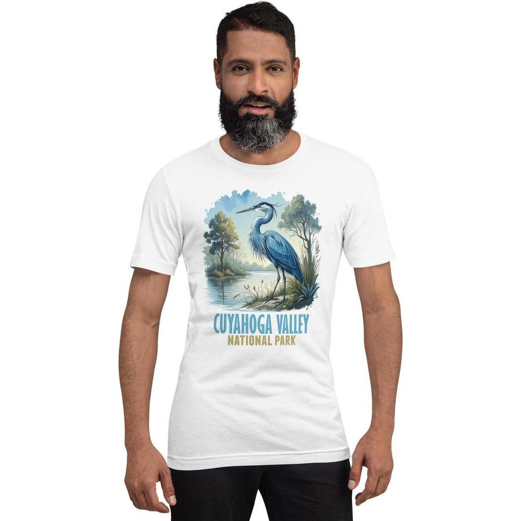 A front view of a man wearing a white Cuyahoga Valley Clothing Company CVNP Blue Heron T - Shirt with a blue heron graphic on the chest.