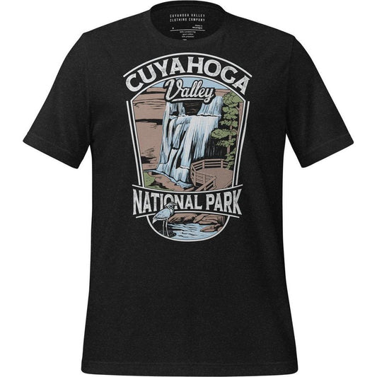 A black heather Cuyahoga Valley Clothing Company CVNP Brandywine Falls T - Shirt with a graphic of a waterfall and trees on the front.