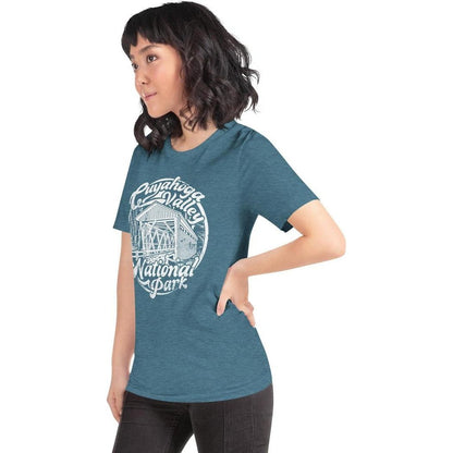 Side view of the Cuyahoga Valley Clothing Company CVNP Covered Bridge T-Shirt in Heather Deep Teal on a model against a white background.