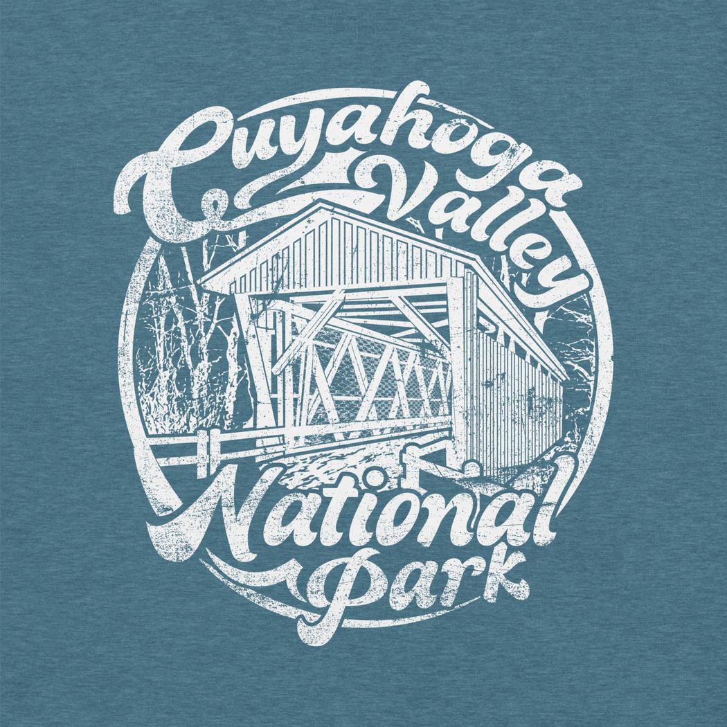 A heather deep teal Cuyahoga Valley Clothing Company CVNP Covered Bridge T - Shirt with a white graphic of a covered bridge and text.