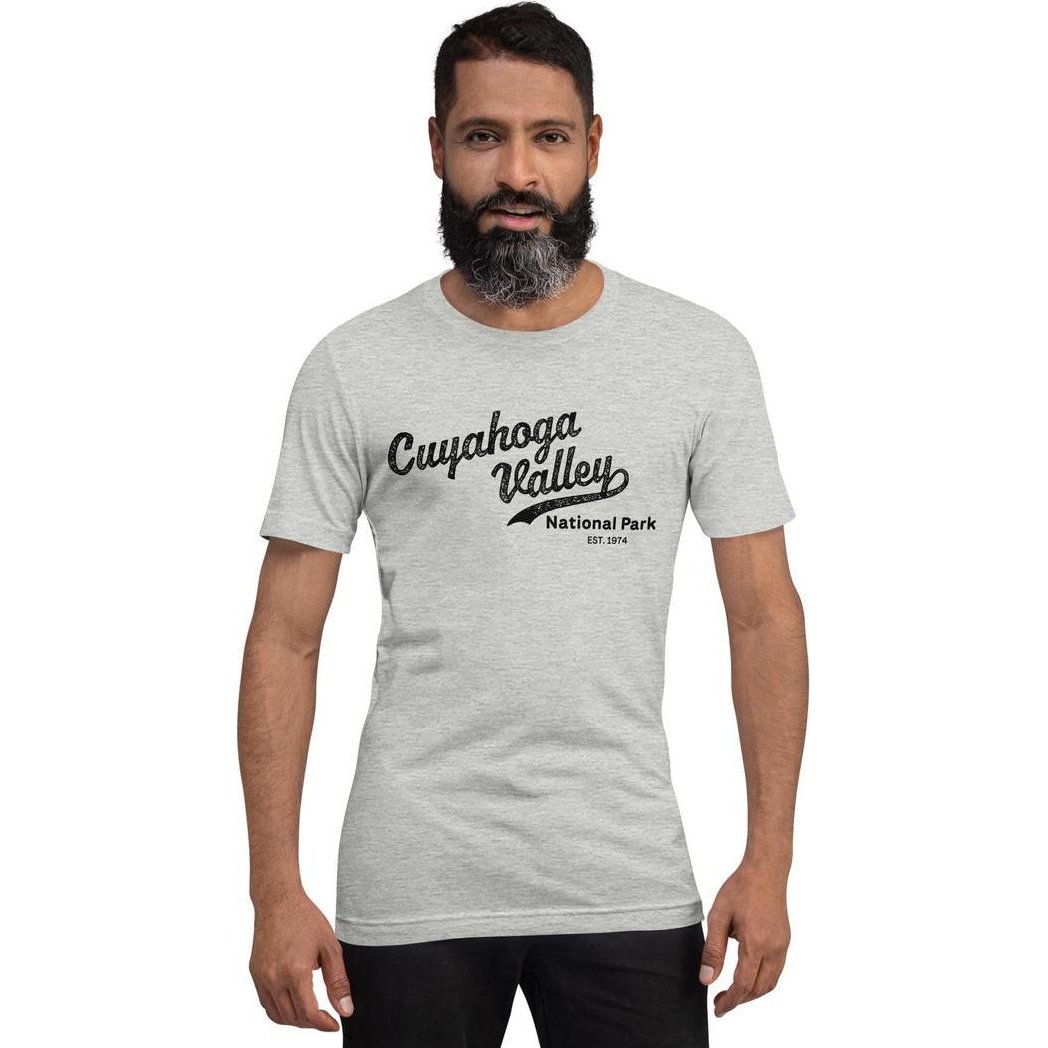 A front view of a man wearing a gray Cuyahoga Valley National Park vintage script t - shirt against a white background.