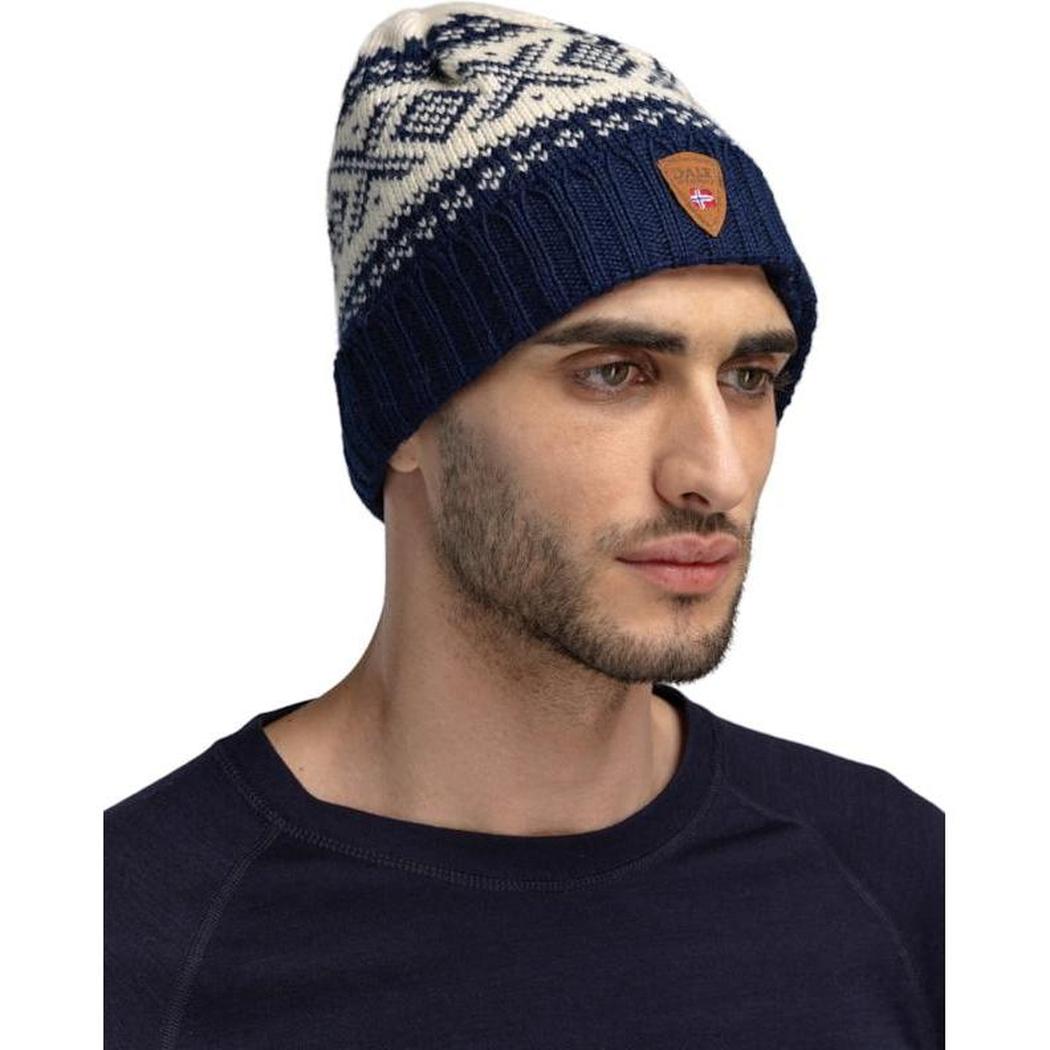 Side view of the Dale Of Norway Cortina 1956 Hat in Navy White on a model wearing a dark shirt against a white background.