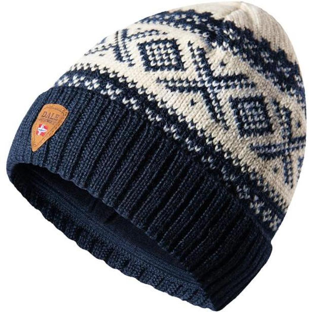 A side view of the Dale Of Norway Cortina 1956 Hat in Navy White showing the pattern and leather tag against a white background.