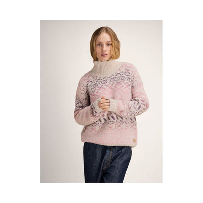 A model wearing the Dale Of Norway Highland Feminine Sweater-SAMPLE in OffWhtPinkOmbre stands against a plain background.