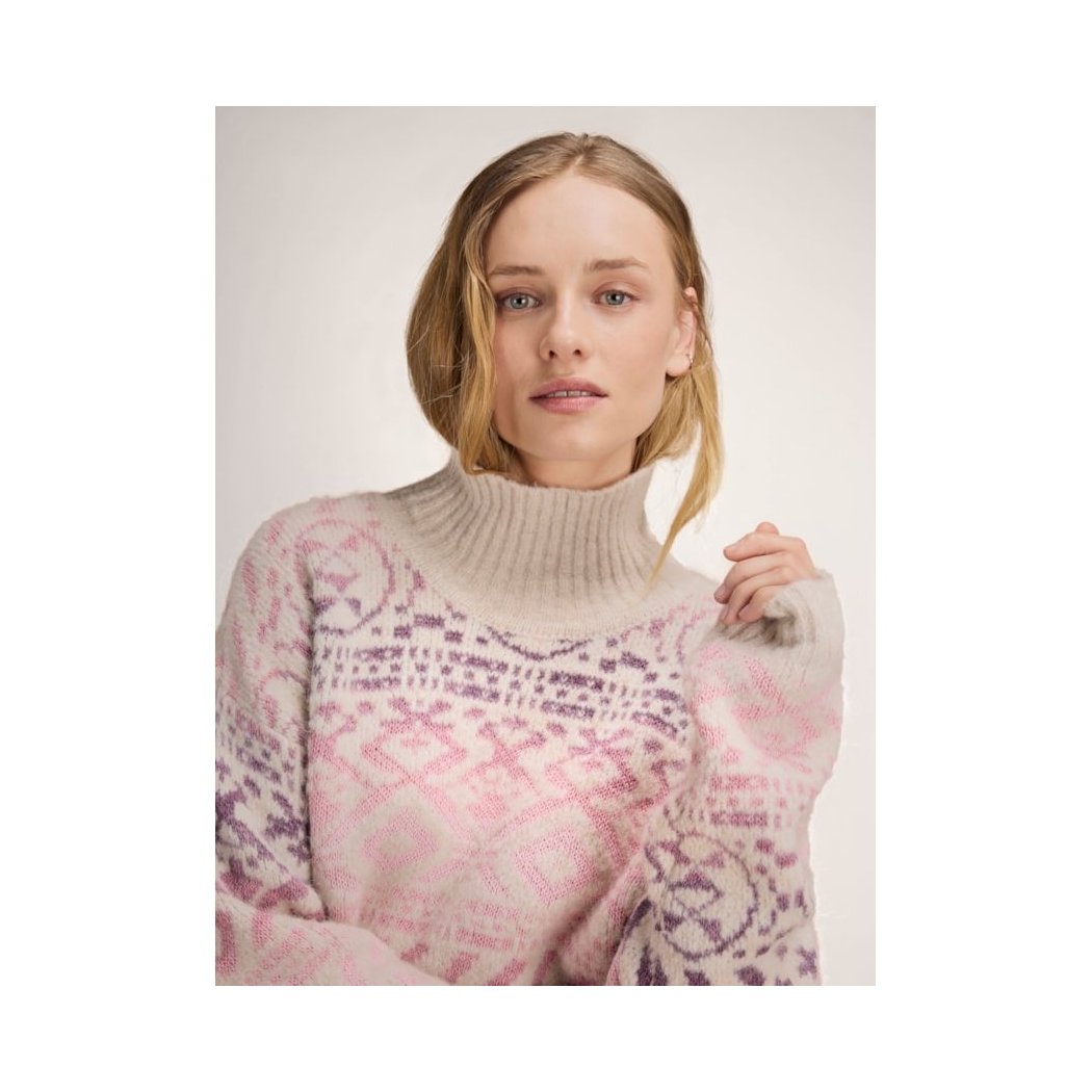 A model wearing the Dale Of Norway Highland Feminine Sweater-SAMPLE in OffWhtPinkOmbre against a light background.