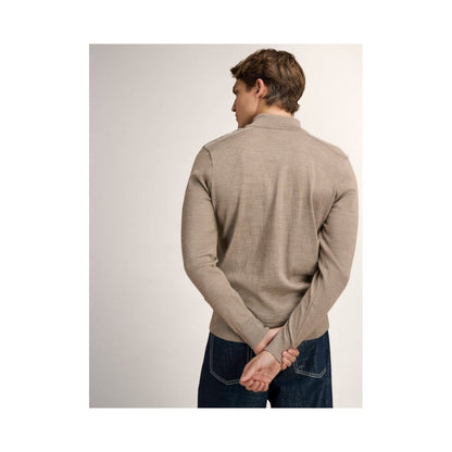 Back view of the Dale Of Norway Liaset Masc. Sweater-SAMPLE in MtnStneOffWht on a model with hands behind back against a light background.