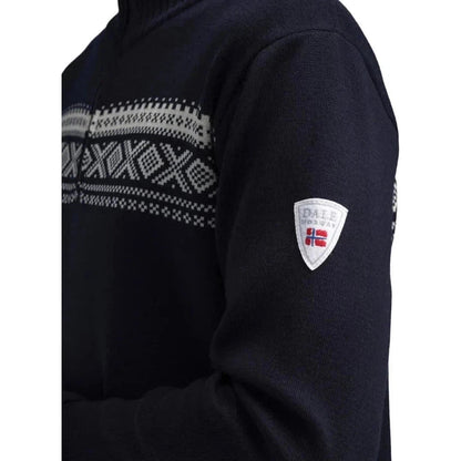 Side view of the Dale Of Norway Men's Dalestølen Sweater in Navy Offwhite showing the pattern on the chest and the brand patch on the sleeve.