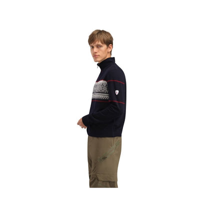 Side view of the Dale Of Norway Moritz Masc Basic Sweater-SAMPLE in NavyWhtRaspberr on a model wearing khaki pants against a white background.