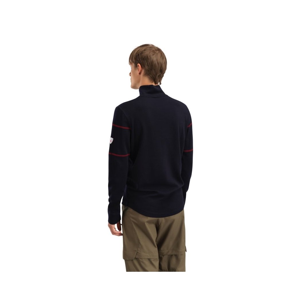 Back view of the Dale Of Norway Moritz Masc Basic Sweater-SAMPLE in NavyWhtRaspberr on a model wearing khaki pants against a white background.