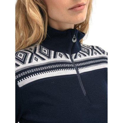 A close-up of the Dale Of Norway Women's Cortina Basic Sweater in Navy Off White, showing the high collar and patterned upper section on a model with blonde hair.