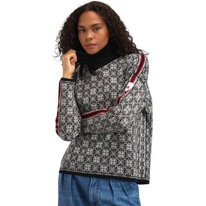 A model wears the Dale Of Norway Women's Firda Sweater in Black Offwhite with a white background.
