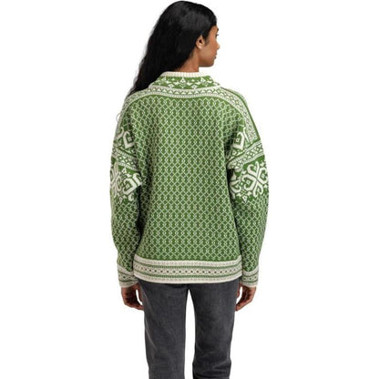 Back view of the Dale Of Norway Women's Leknes Sweater in Springgreen Offwhite Sand Mel on a model wearing dark pants against a white background.
