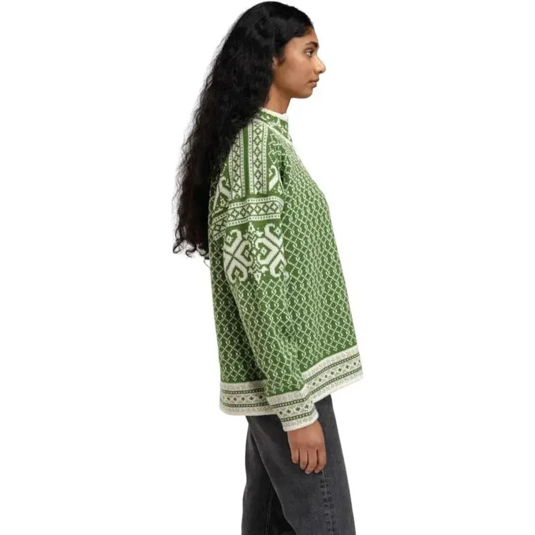 Side view of the Dale Of Norway Women's Leknes Sweater in Springgreen Offwhite Sand Mel showing the pattern and cuffs against a white background.
