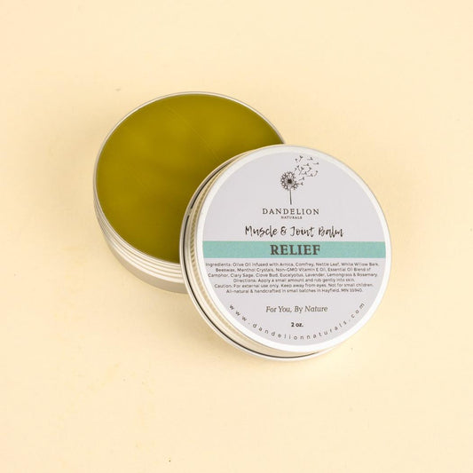 A close up of the Dandelion Naturals Relief Muscle and Joint Balm in a tin on a light background.