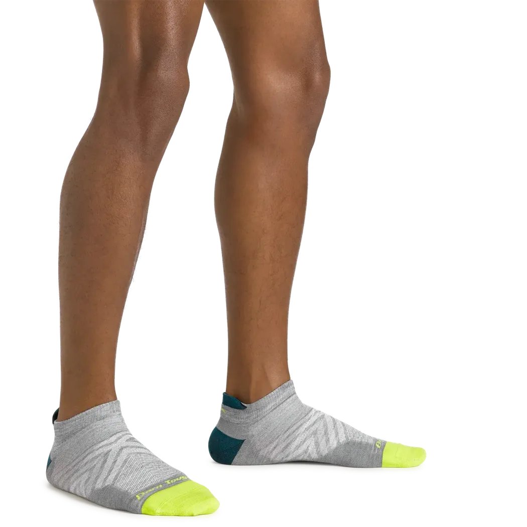 Side view of the Darn Tough Men's Run No Show Tab Ultra-Lightweight Running Socks in Gray on a model against a white background.