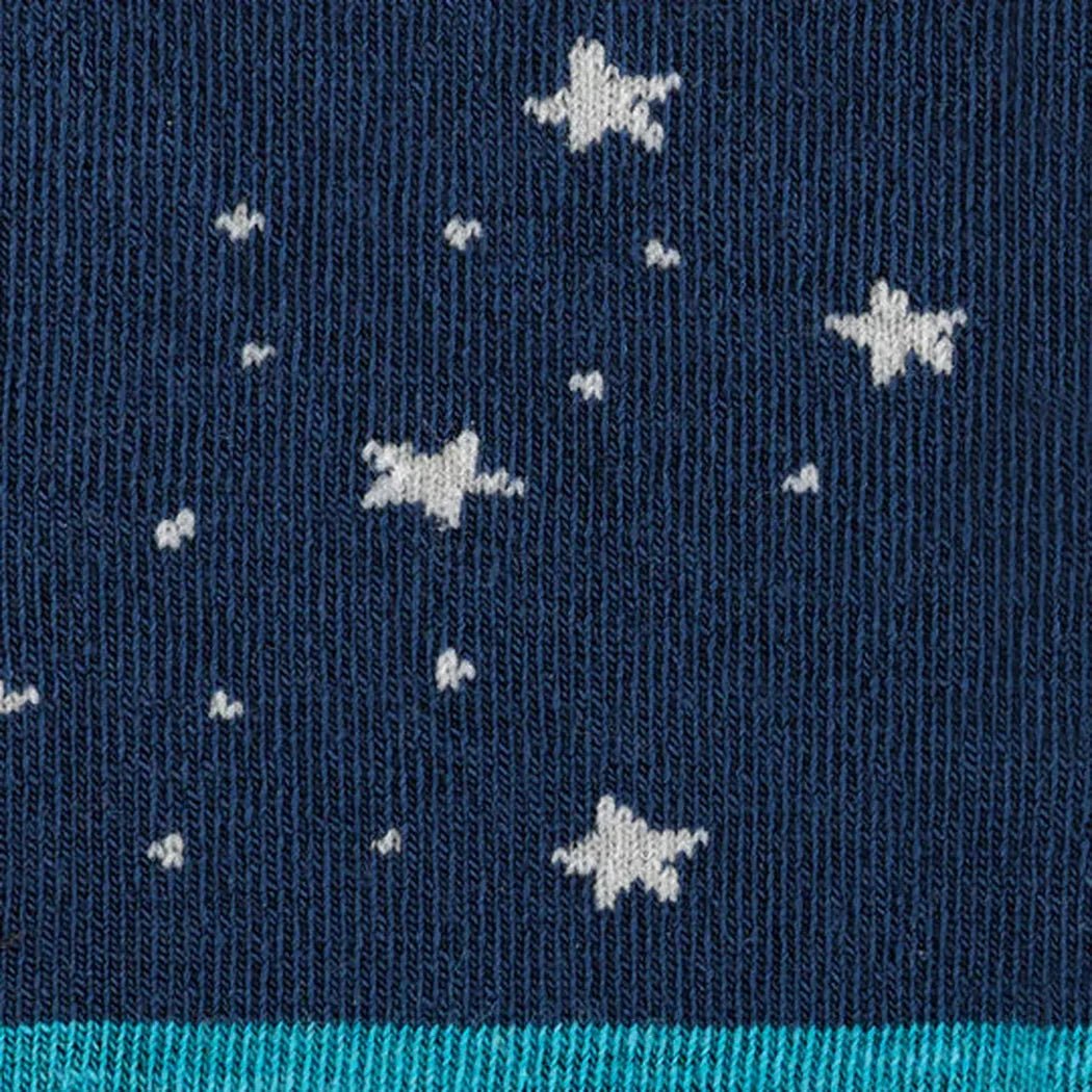 A close-up of the Darn Tough Women's Animal Haus Crew Lightweight socks in Bunny Blue showing white star patterns on a dark blue background.
