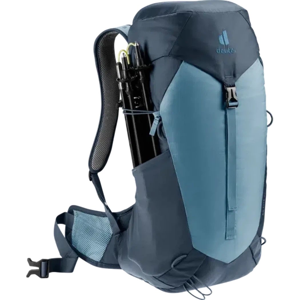 Side view of the Deuter AC Lite 24 in Atlantic Ink showing the trekking pole holder and mesh shoulder straps against a white background.