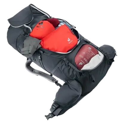 A top-down view of the Deuter Aircontact Core 50 + 10 black backpack showing its main compartment with orange items and a red sleeping bag visible against a white background.