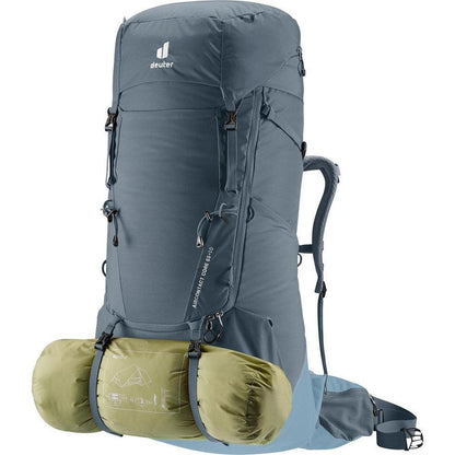 A front view of the Deuter Aircontact Core 65 + 10 backpack in Graphite Shale with a rolled sleeping bag attached, against a white background.