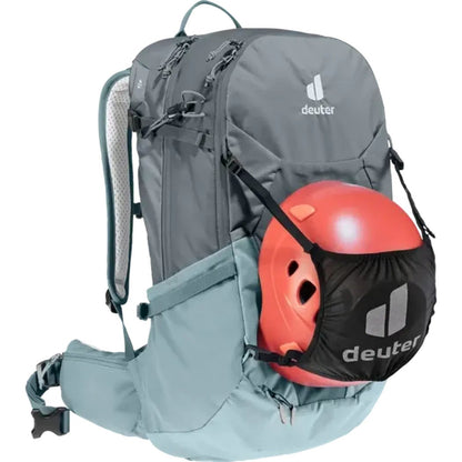 Side view of the Deuter Futura 25 SL backpack in Graphite Shale with a red helmet attached against a white background.