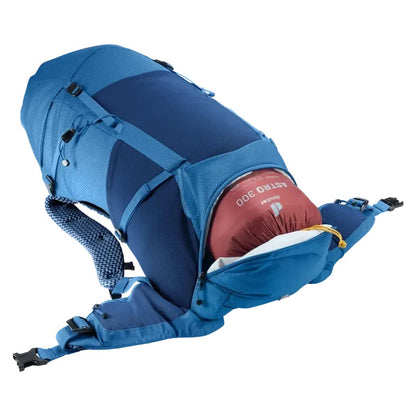 Side view of the Deuter Futura 32 in Nightblue Baltic showing the front compression straps and a red sleeping bag inside against a white background.