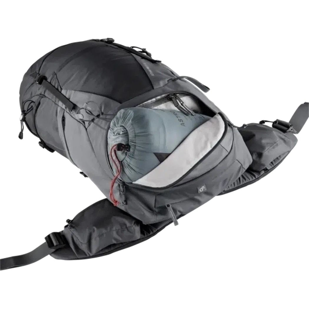 A side view of the Deuter Futura Pro 34 SL in Black Graphite showing the main compartment open with a sleeping bag inside against a white background.