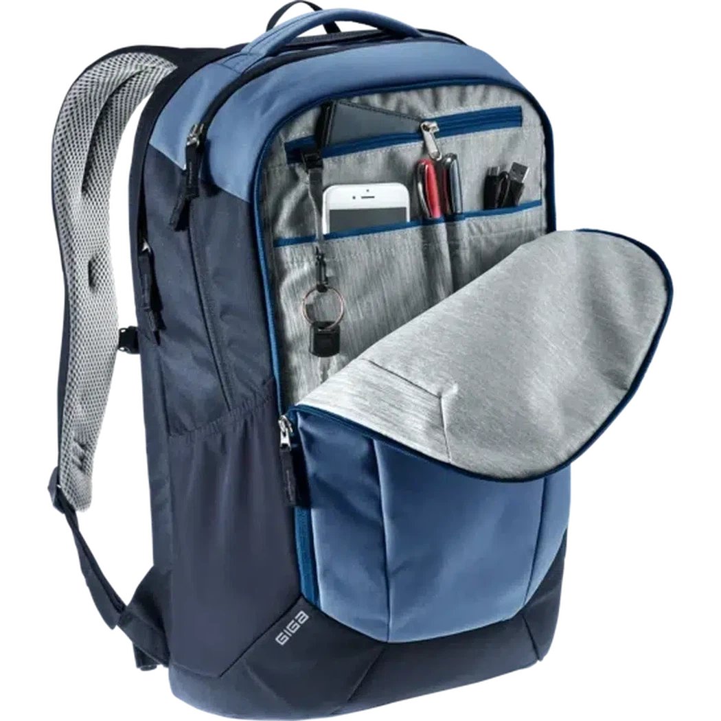 A front view of the Deuter Giga daypack in Marine Ink showing the open front pocket with a phone and pens inside against a white background.