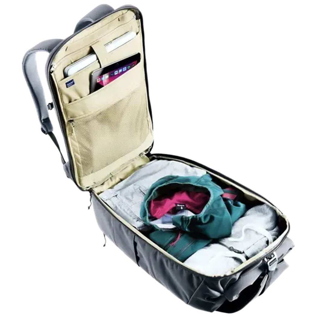 Back view of the Deuter Utilion 30 backpack in Black showing the organized interior with clothing and a phone pocket against a white background.