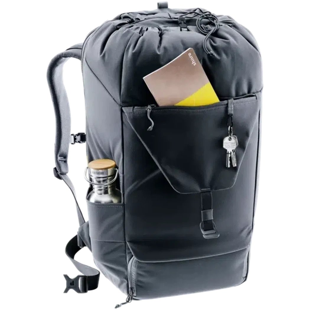 A front view of the Deuter Utilion 34+5 black backpack showing the front pocket with keys and a passport, and a water bottle in the side pocket against a white background.