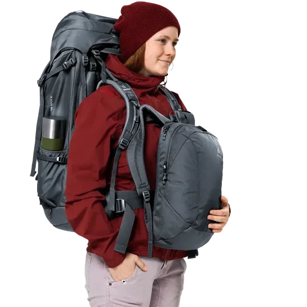 Side view of the Deuter Voyager 60+10 SL backpack in Black showing the large main compartment and a model wearing it against a white background.