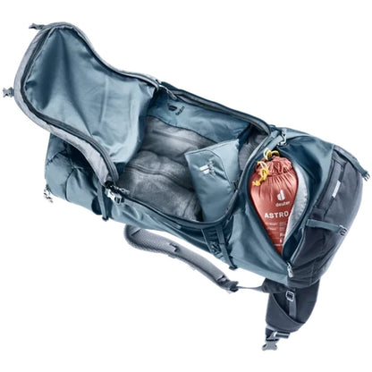 Top-down view of the Deuter Voyager 65+10 in Atlantic Ink showing the main compartment and a red Astro sleeping bag inside against a white background.