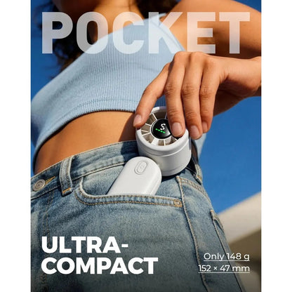 A woman in blue jeans holds the black Diveblues iTurbo Handheld Fan from her pocket against a blue sky.