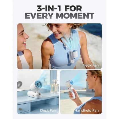 A woman in a blue top wears the black Diveblues iTurbo Handheld Fan as a neck fan outdoors.