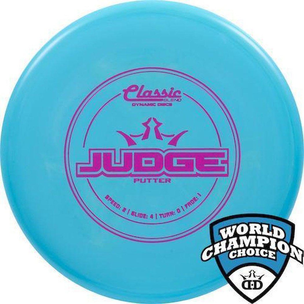 A blue Dynamic Discs Classic Blend Judge putter disc with purple text and a World Champion Choice logo in the corner.