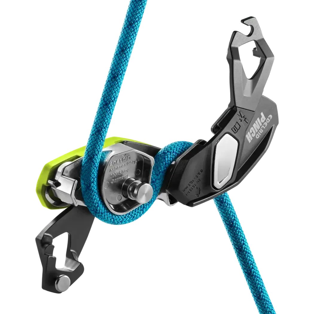 A close-up of the Edelrid Pinch belay device in Anthracite/Oasis color, showing the blue rope wrapped around it against a white background.